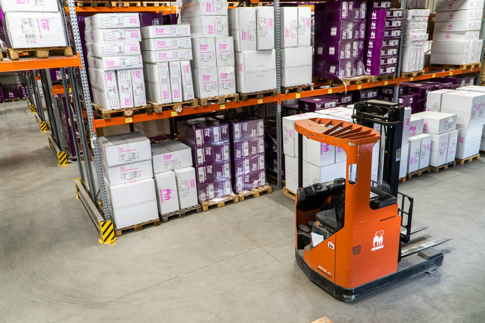 Forklift truck in a warehouse aisle